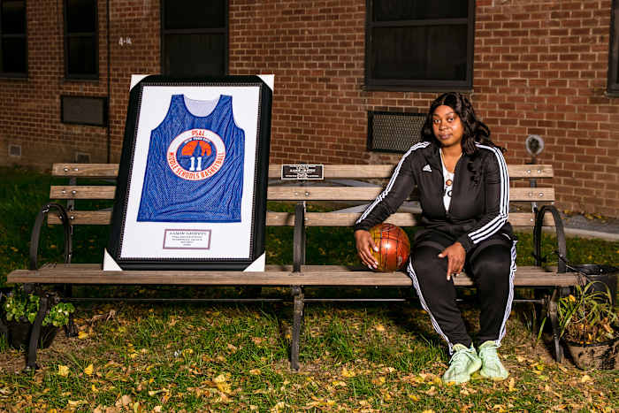 Aamir Griffin's mother, Shanequa, sits on a bench dedicated to her son.